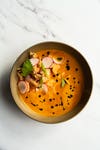 A bowl of soup on a marble surface