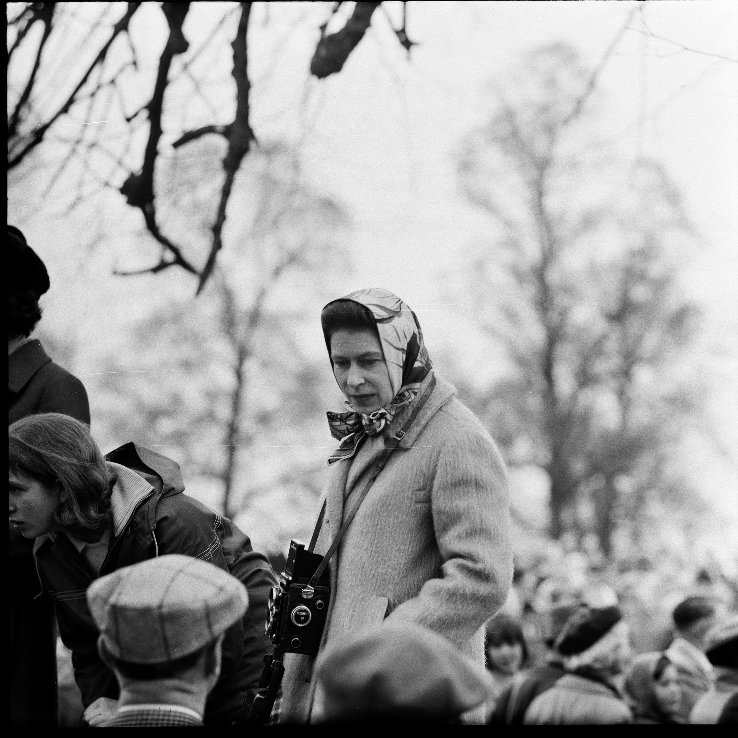 Queen Elizabeth II carrying a Rolleiflex camera at Badminton Horse Trials, United Kingdom, circa 1965.